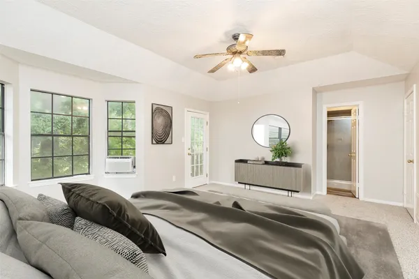 a bedroom with a bed and glass window