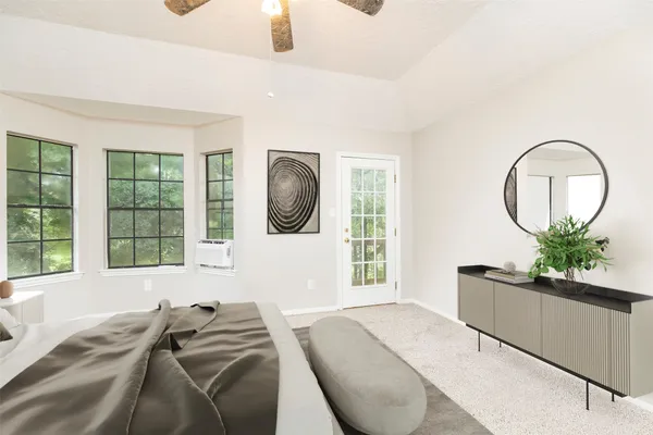 a bedroom with a bed and a large mirror on the dresser