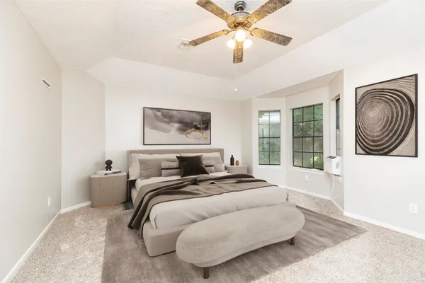 a bedroom with a bed and a large window