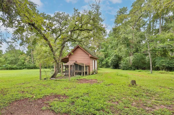a house with green field in front of it