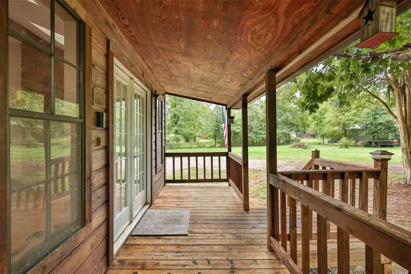 a view of a balcony with wooden floor