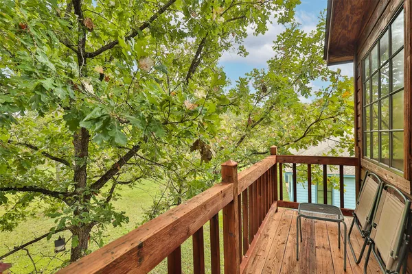 a view of a balcony with wooden fence