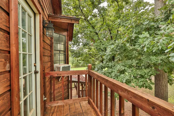 a view of a balcony with wooden floor and fence