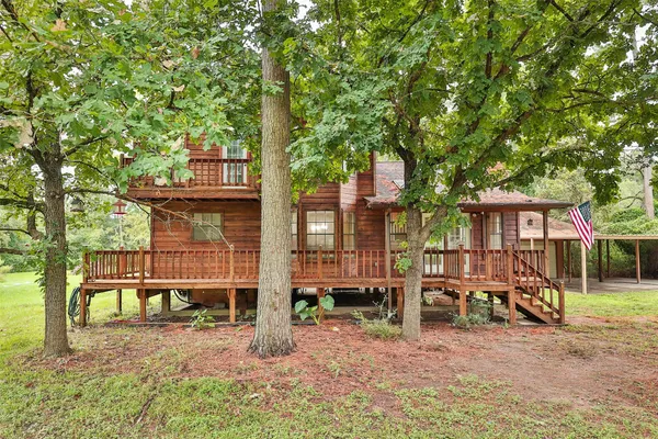 a view of a chair and tables in the back yard