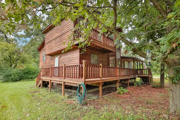 a small house in middle of the green field
