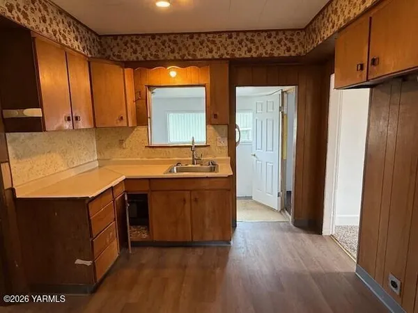 a kitchen with stainless steel appliances granite countertop a sink and a stove