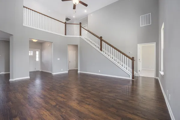 a kitchen with stainless steel appliances granite countertop wooden floors and white cabinets