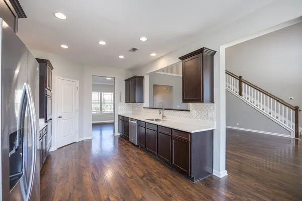 a kitchen with stainless steel appliances a refrigerator and a sink