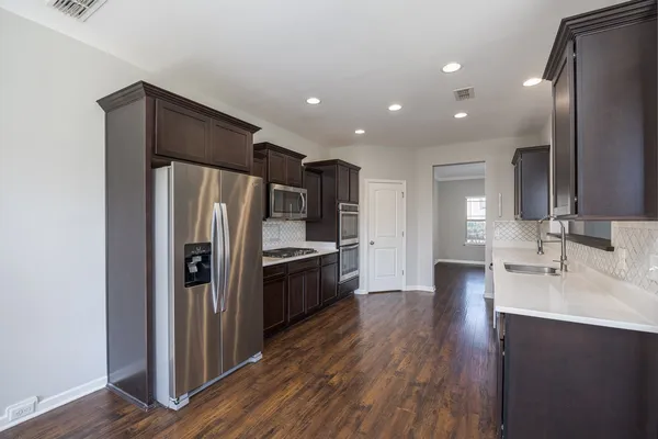 a kitchen with kitchen island a counter space and refrigerator