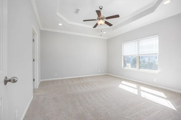 a view of empty room with a ceiling fan and window