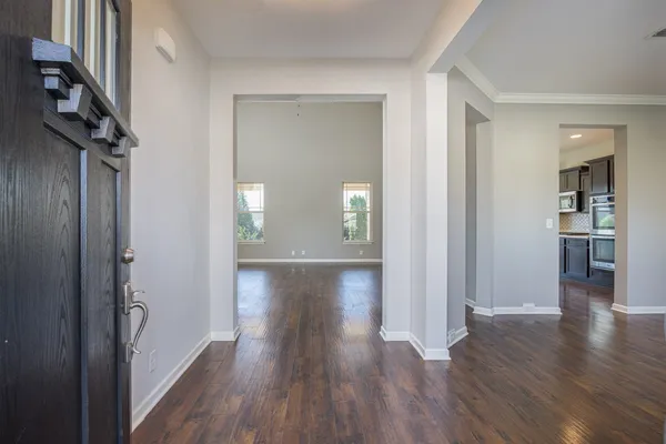 a view of hallway with wooden floor