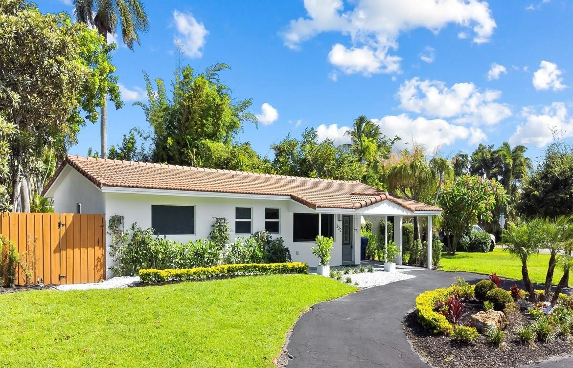 332 Northeast 29th Street Wilton Manors, FL 33334 - Photo 1 of 28 a front view of a house with a yard