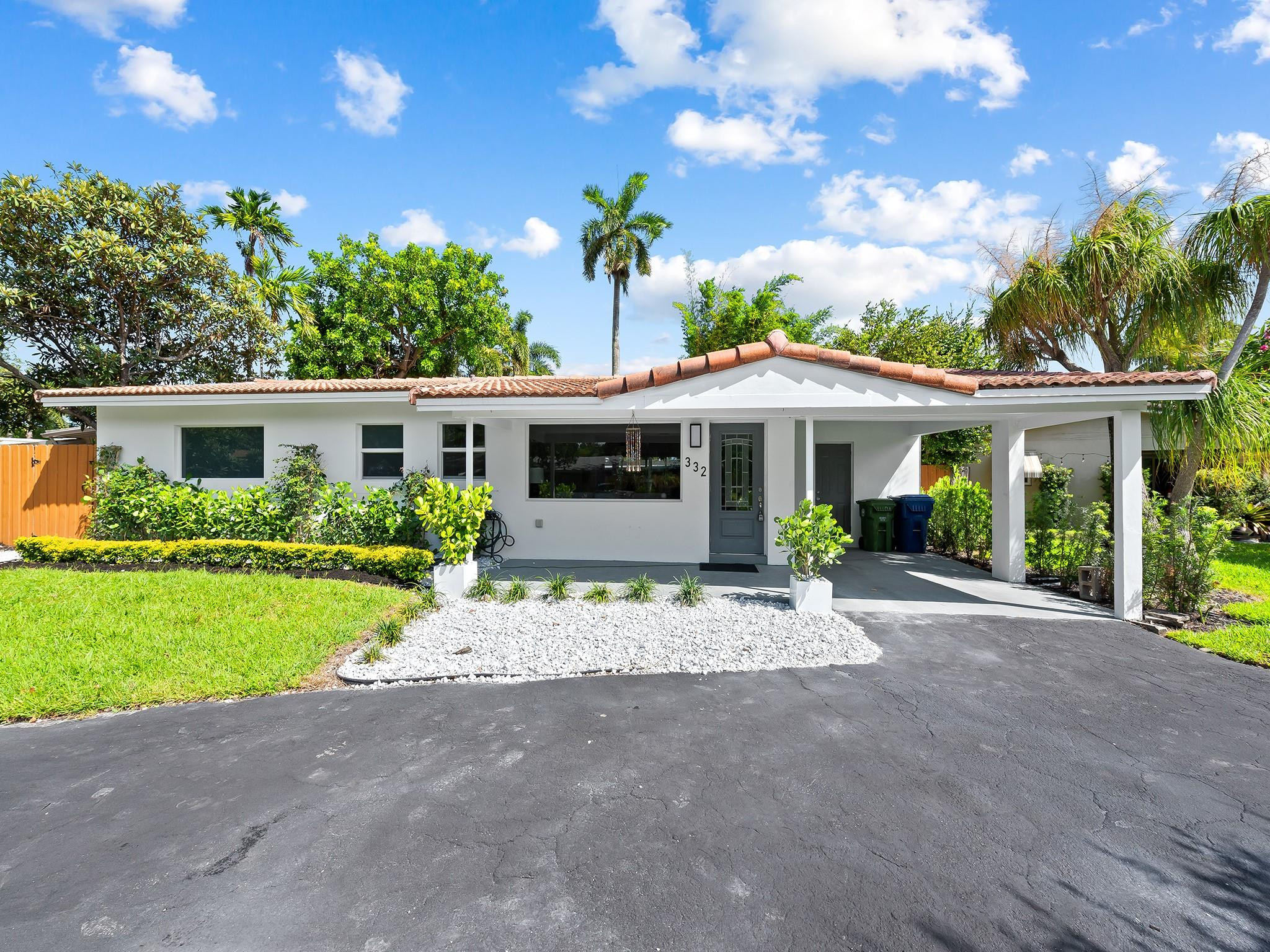 332 Northeast 29th Street Wilton Manors, FL 33334 - Photo 22 of 28 a front view of a house with a garden and porch