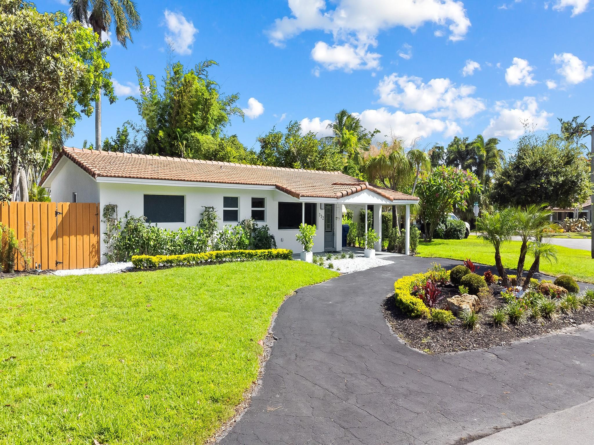 332 Northeast 29th Street Wilton Manors, FL 33334 - Photo 24 of 28 a front view of a house with garden