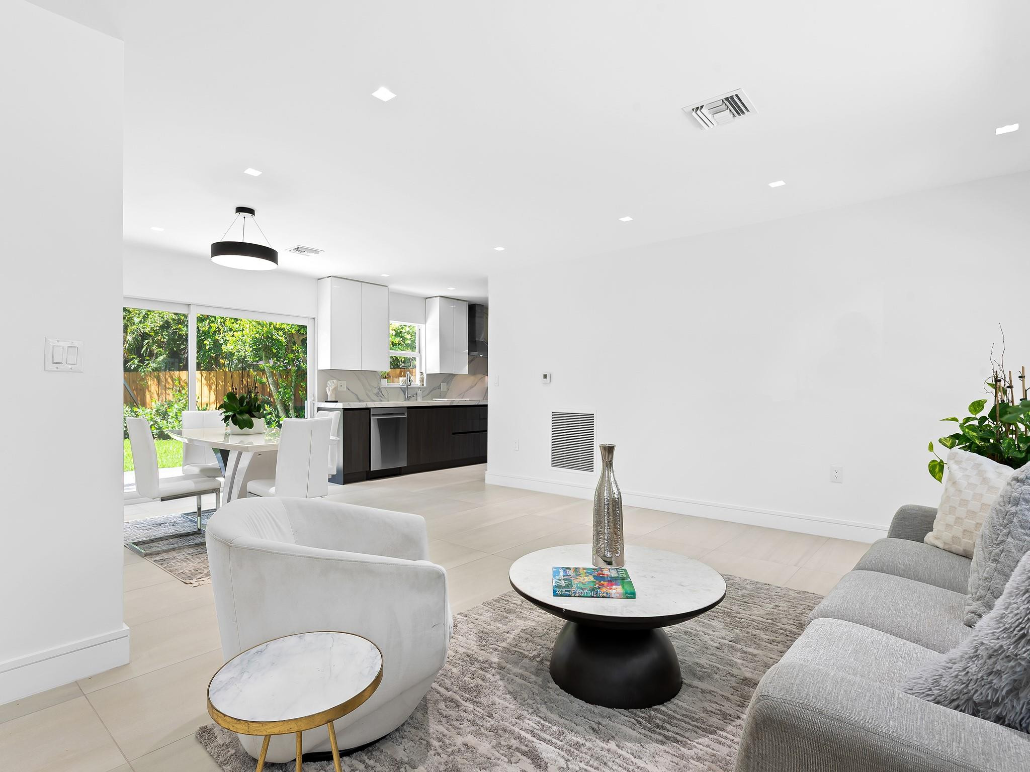 332 Northeast 29th Street Wilton Manors, FL 33334 - Photo 7 of 28 a living room with furniture and a fireplace