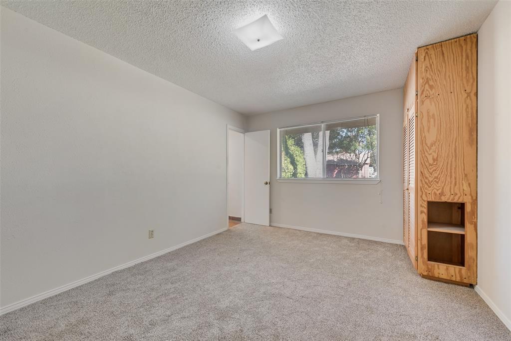 703 Rolling Ridge Lane Duncanville, TX 75116 - Photo 21 of 38 Unfurnished room with light carpet and a textured ceiling