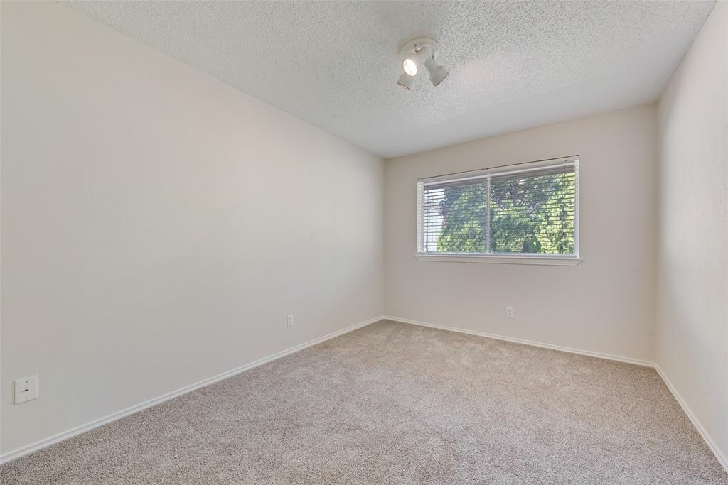 703 Rolling Ridge Lane Duncanville, TX 75116 - Photo 27 of 38 Empty room featuring light carpet and a textured ceiling