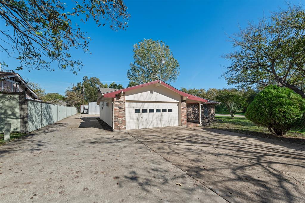 703 Rolling Ridge Lane Duncanville, TX 75116 - Photo 32 of 38 View of property exterior with driveway, brick siding, and a garage