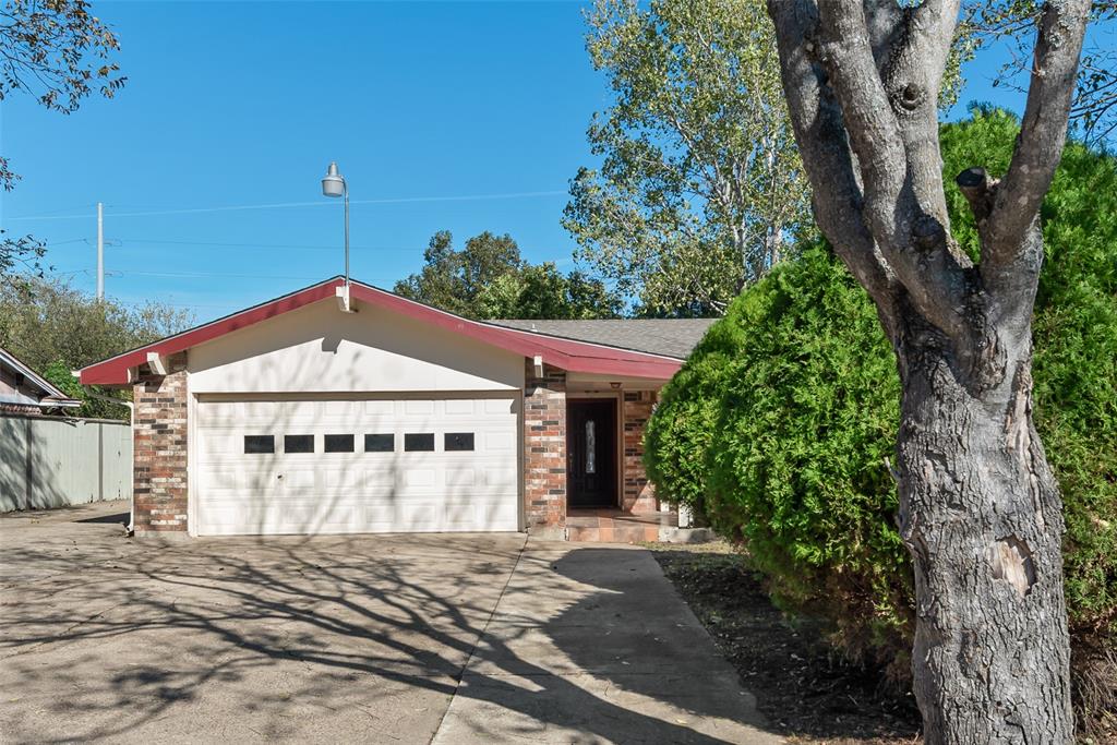 703 Rolling Ridge Lane Duncanville, TX 75116 - Photo 36 of 38 View of front facade with brick siding, driveway, an attached garage, and a shingled roof