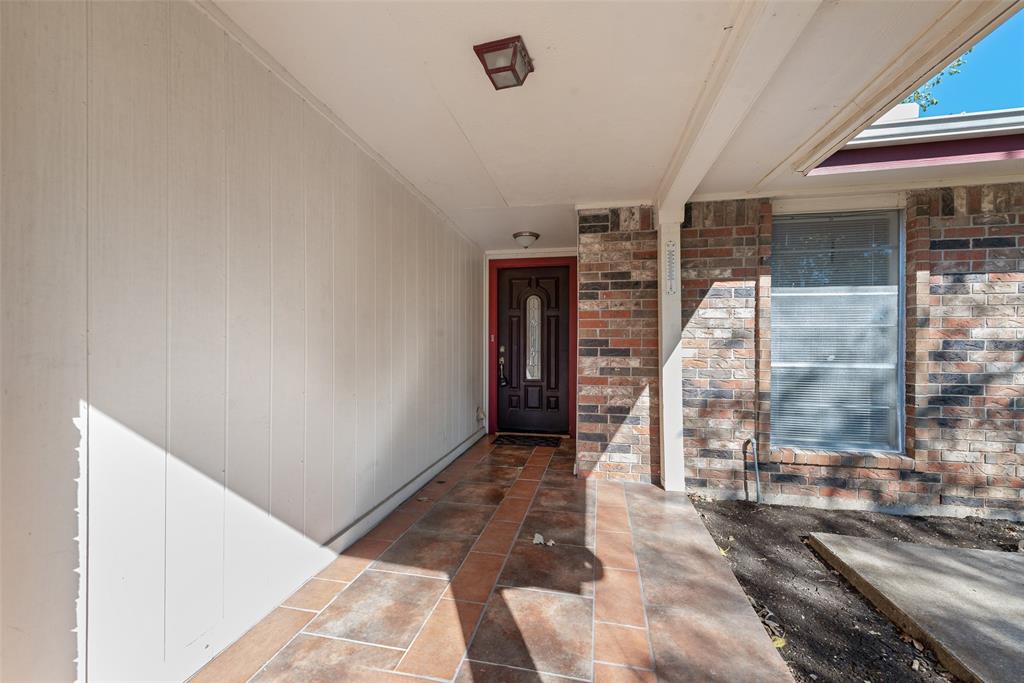 703 Rolling Ridge Lane Duncanville, TX 75116 - Photo 6 of 38 Doorway to property featuring brick siding and a porch