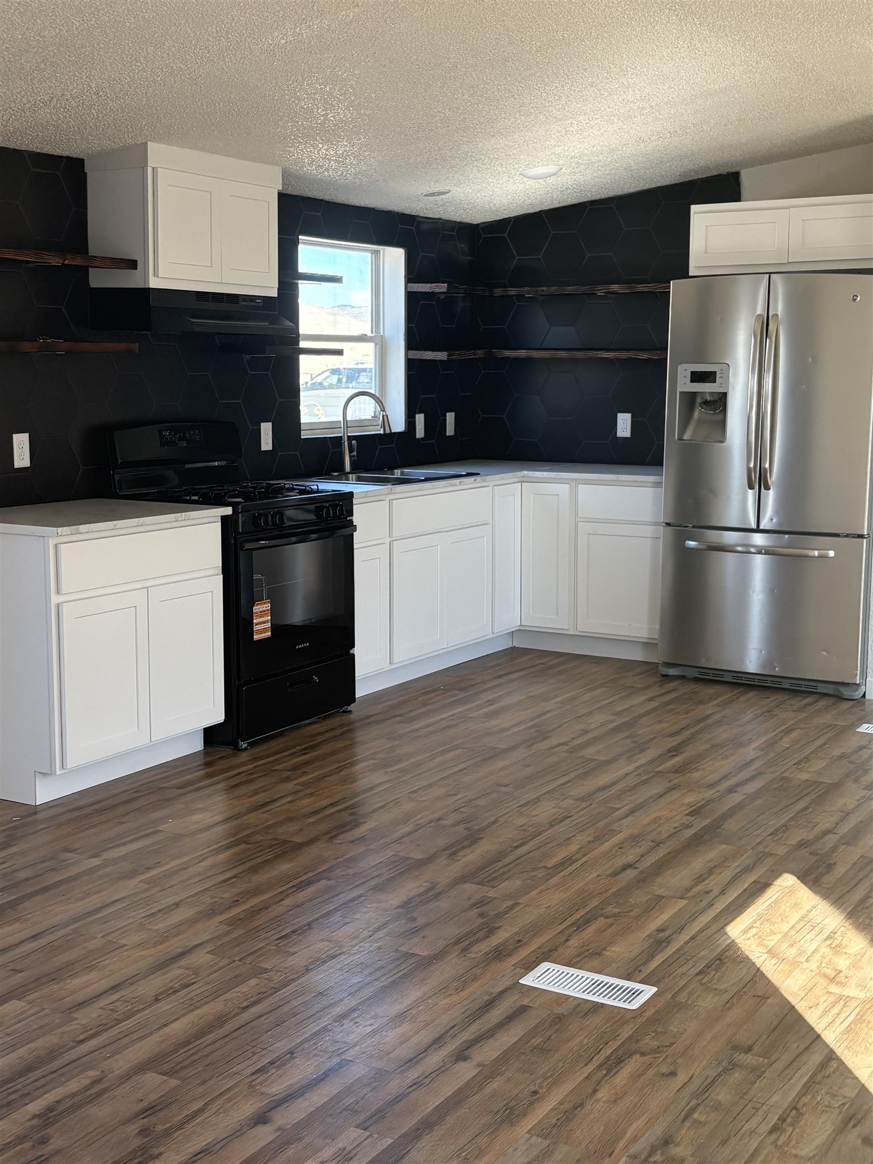 424 32 Road, Unit 374 Clifton, CO 81520 - Photo 9 of 11 a kitchen with granite countertop a refrigerator and a stove top oven