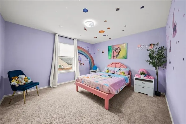 a bedroom with a bed and a potted plant