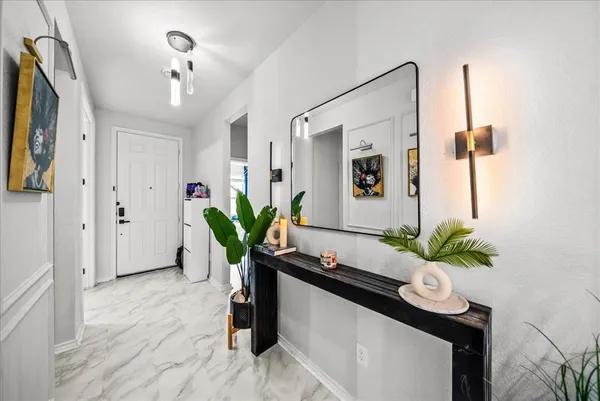 a living room with furniture and a potted plant