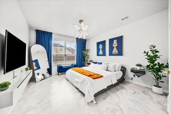 a bedroom with a bed and a flat screen tv