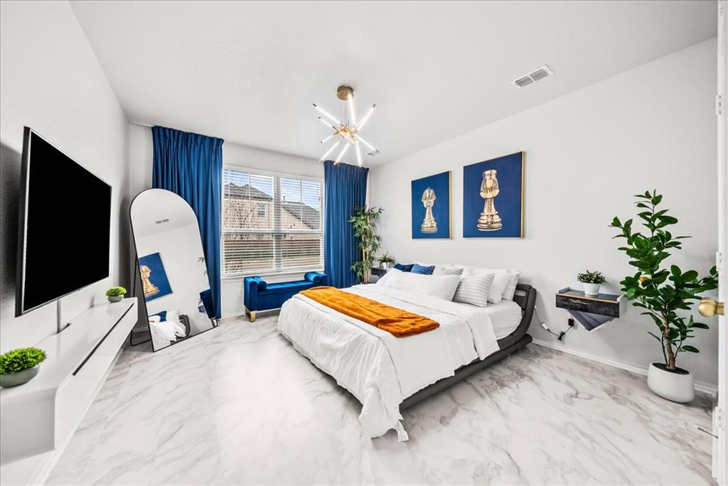 1908 Twisted Tree Lane Mesquite, TX 75149 - Photo 8 of 22 Bedroom featuring light marble finish floors and suspended lighting