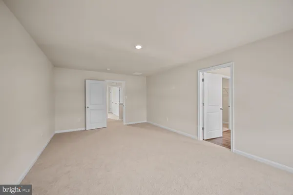 a view of an empty room and closet area