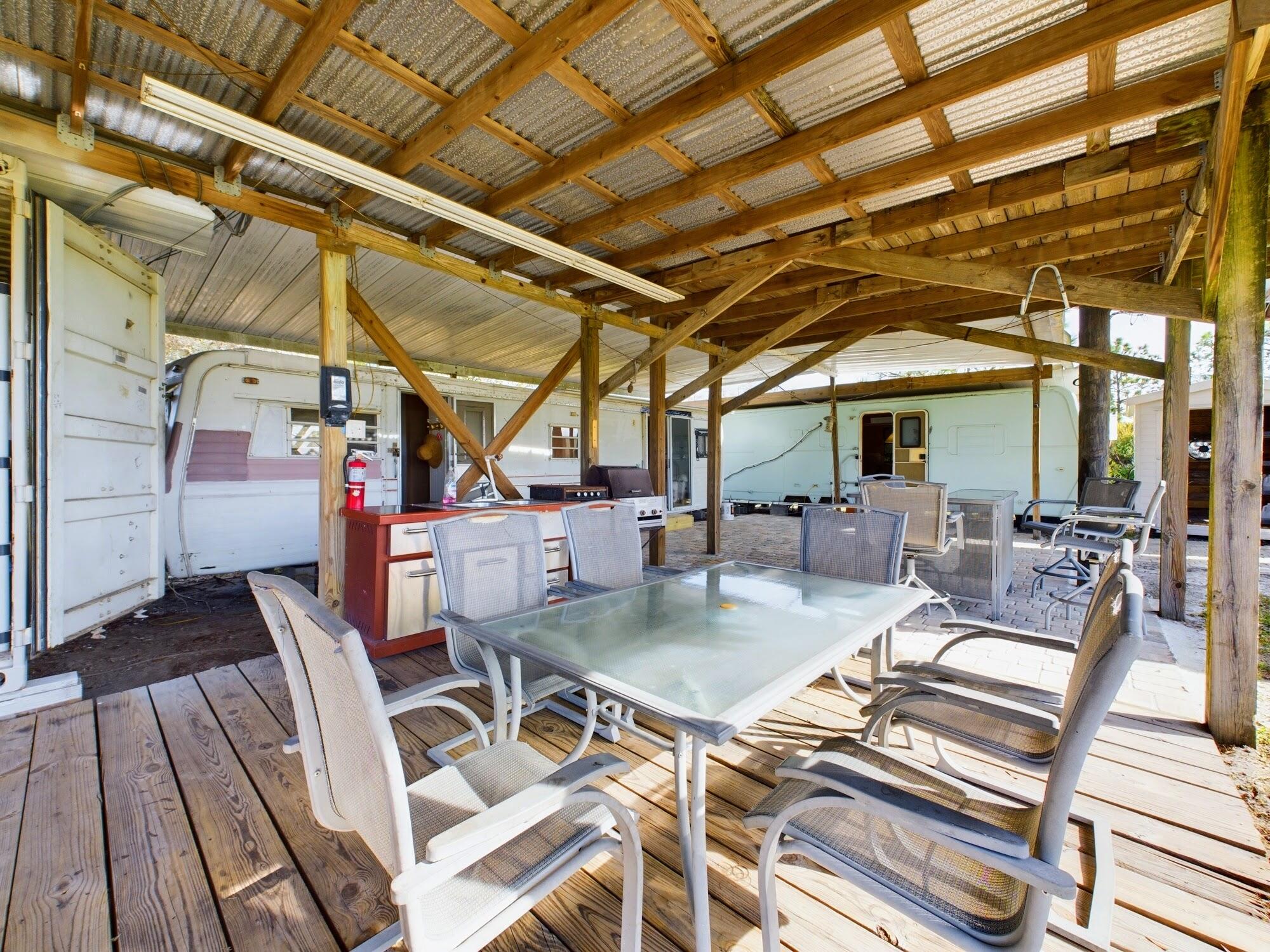 1224001 Holopaw Groves Rd Street St. Cloud, FL 34773 - Photo 16 of 99 a view of a patio with table and chairs