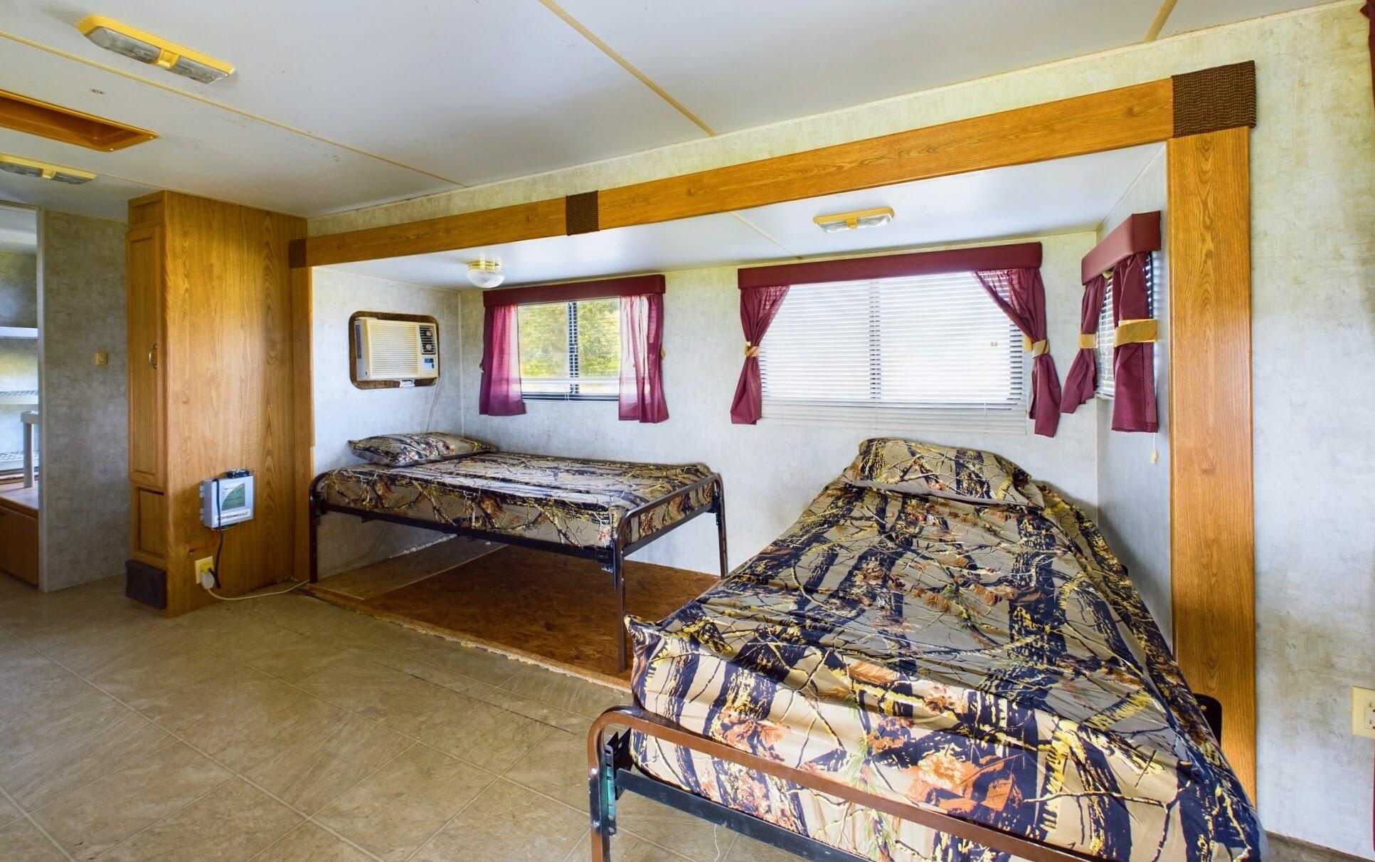 1224001 Holopaw Groves Rd Street St. Cloud, FL 34773 - Photo 21 of 99 a bedroom with three beds and a window