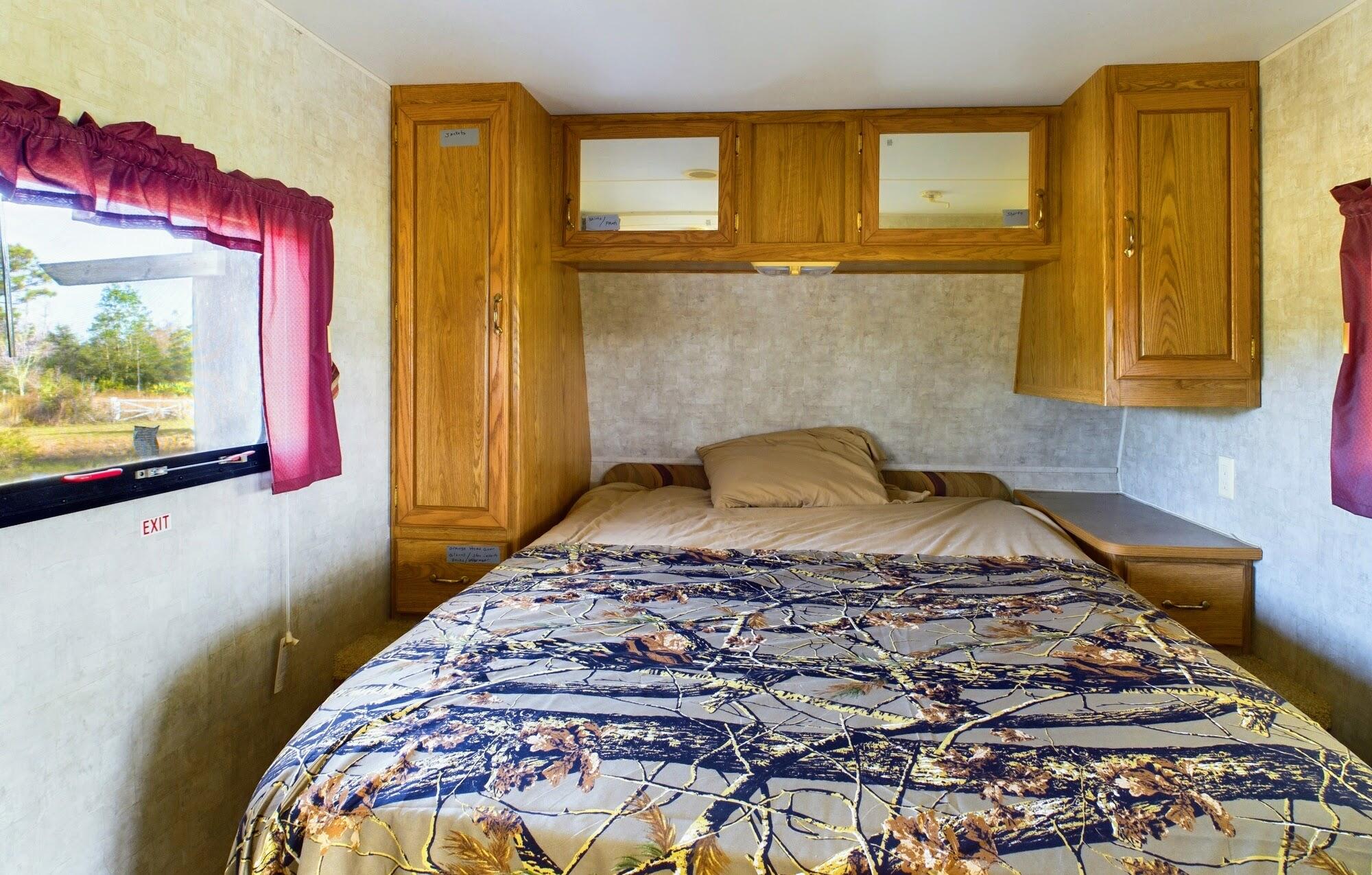 1224001 Holopaw Groves Rd Street St. Cloud, FL 34773 - Photo 25 of 99 a bedroom with a bed and cupboard
