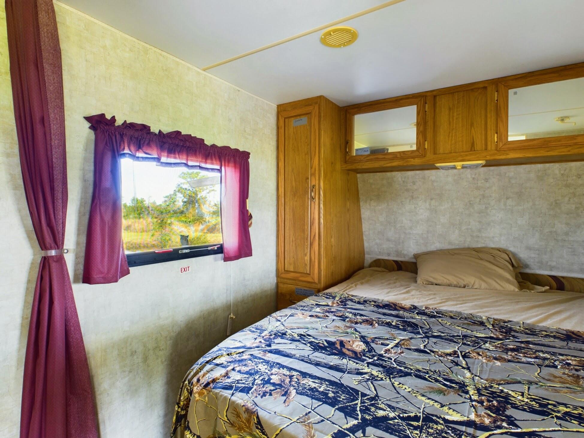 1224001 Holopaw Groves Rd Street St. Cloud, FL 34773 - Photo 26 of 99 a bedroom with a bed and a flat screen tv
