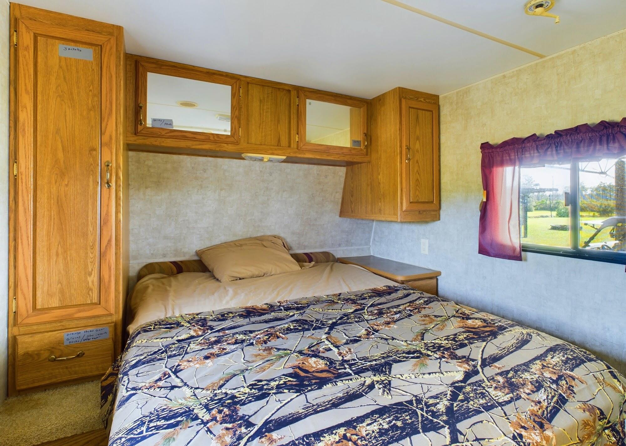 1224001 Holopaw Groves Rd Street St. Cloud, FL 34773 - Photo 27 of 99 a bedroom with a bed and teddy bear on dresser