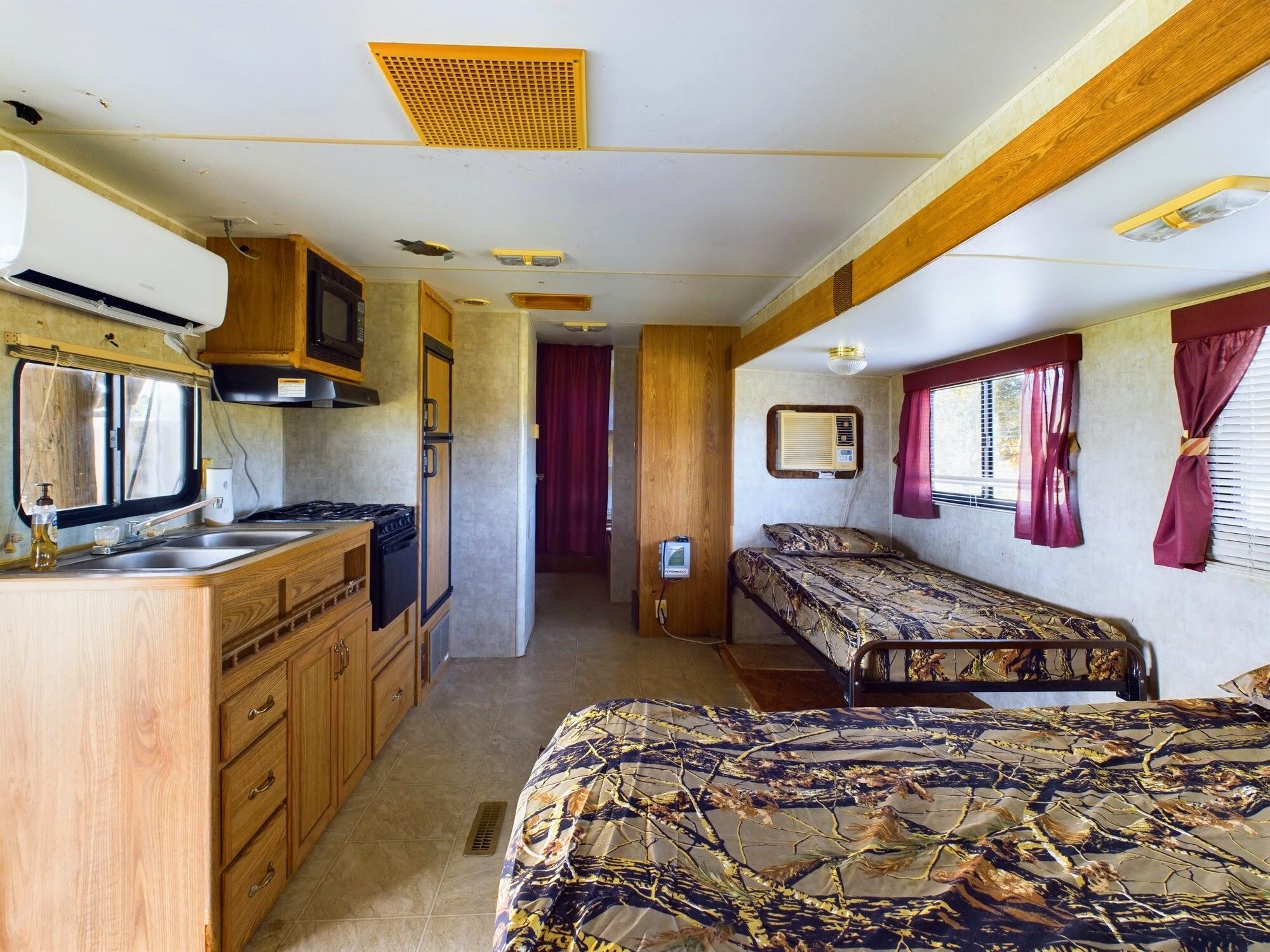 1224001 Holopaw Groves Rd Street St. Cloud, FL 34773 - Photo 28 of 99 a bedroom with a bed and wooden floor