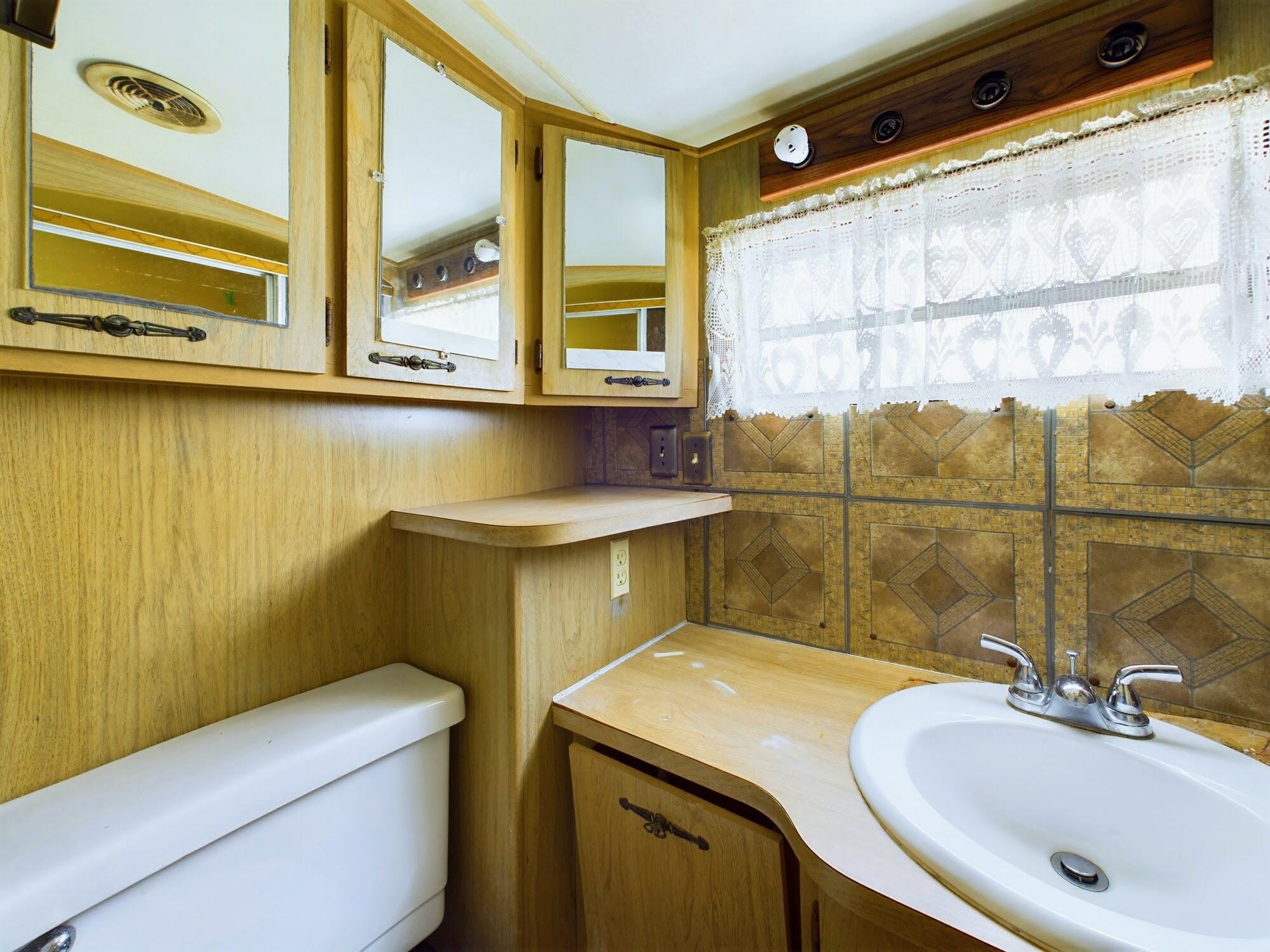 1224001 Holopaw Groves Rd Street St. Cloud, FL 34773 - Photo 50 of 99 a bathroom with a sink and a mirror