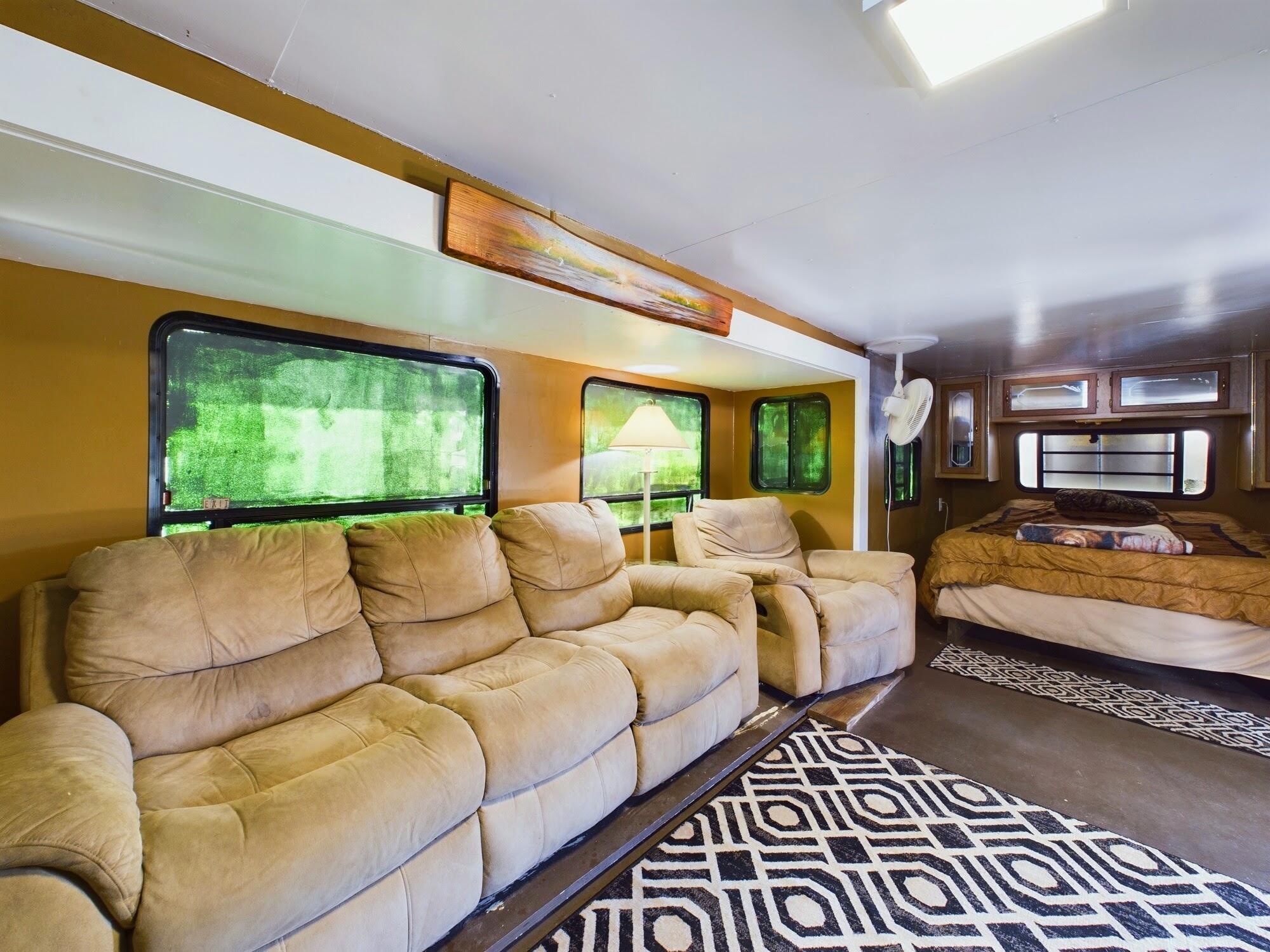 1224001 Holopaw Groves Rd Street St. Cloud, FL 34773 - Photo 56 of 99 a living room with large couches rug and a large window