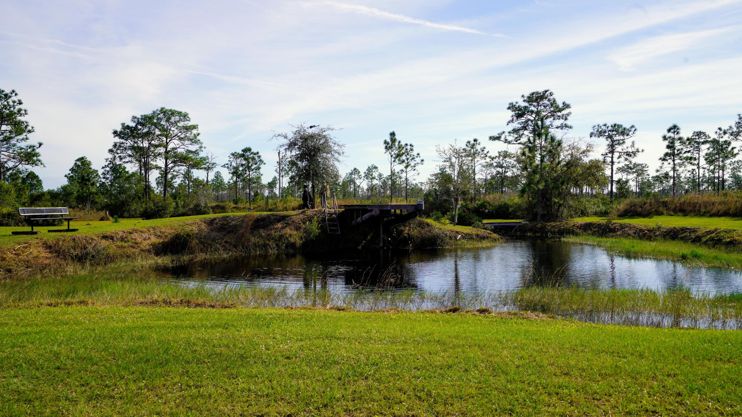 1224001 Holopaw Groves Rd Street St. Cloud, FL 34773 - Photo 6 of 99 a view of a lake with a house in the background