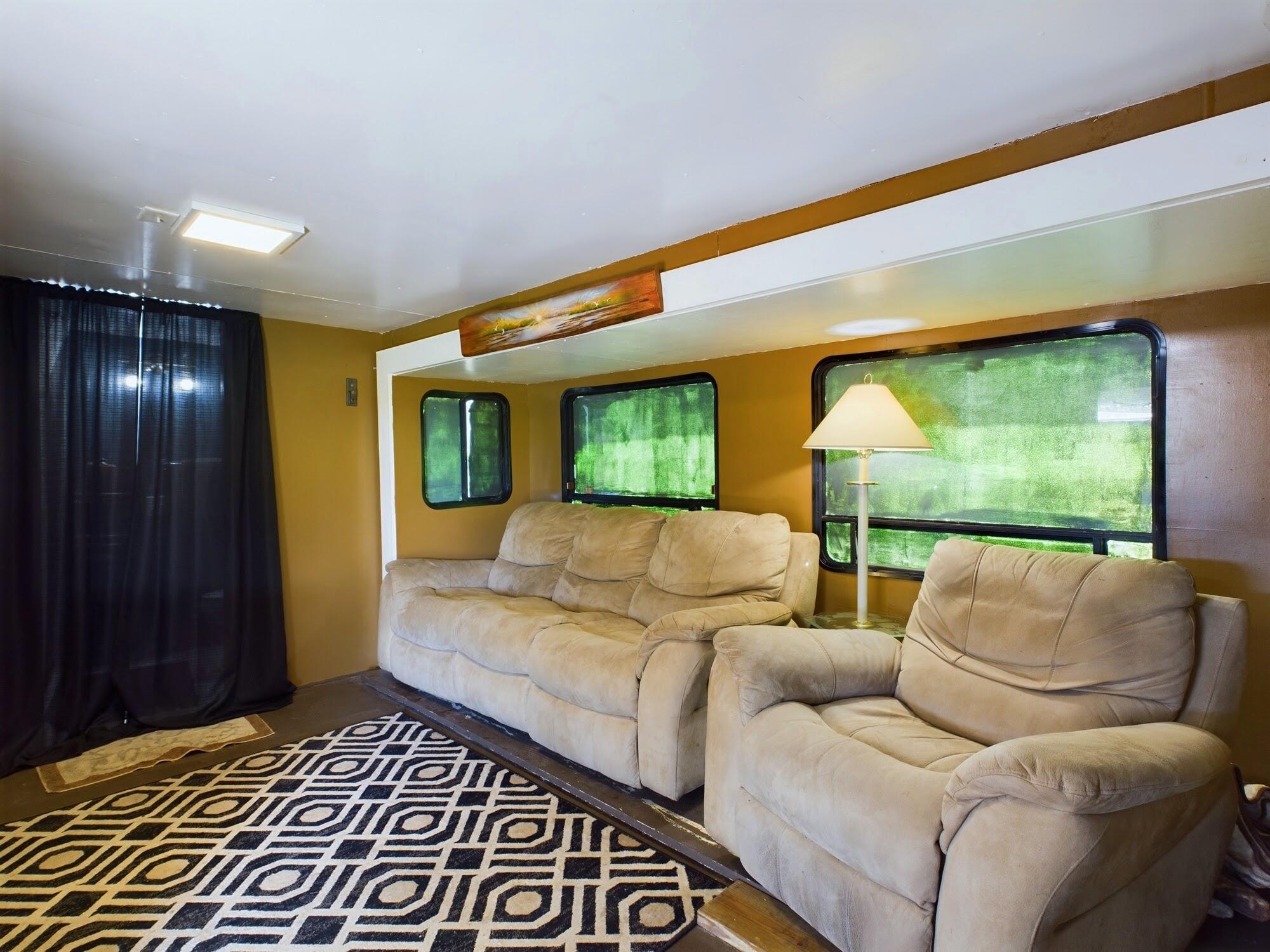 1224001 Holopaw Groves Rd Street St. Cloud, FL 34773 - Photo 62 of 99 a living room with furniture and a gate