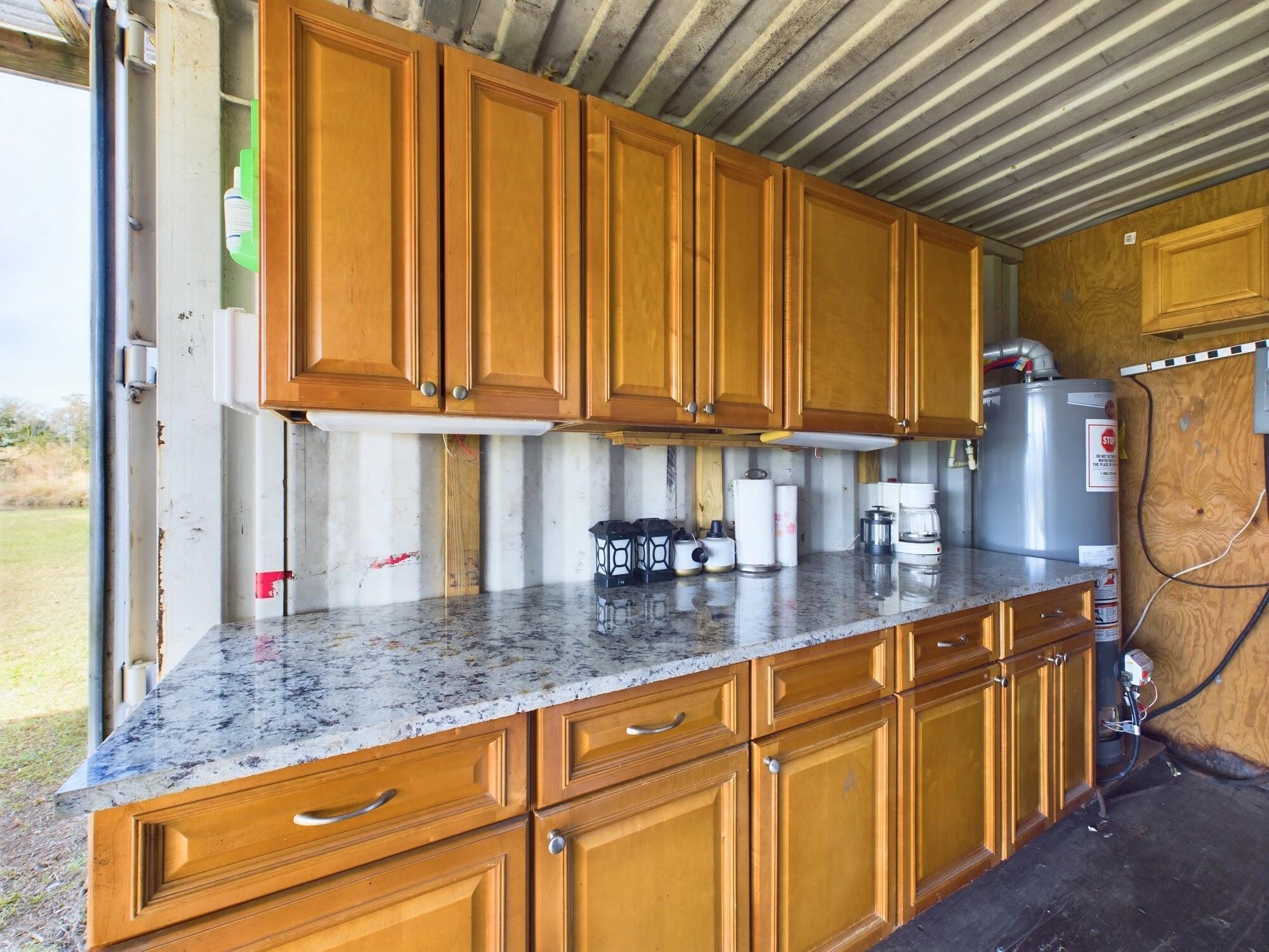 1224001 Holopaw Groves Rd Street St. Cloud, FL 34773 - Photo 68 of 99 a kitchen with stainless steel appliances granite countertop a sink a counter space and cabinets