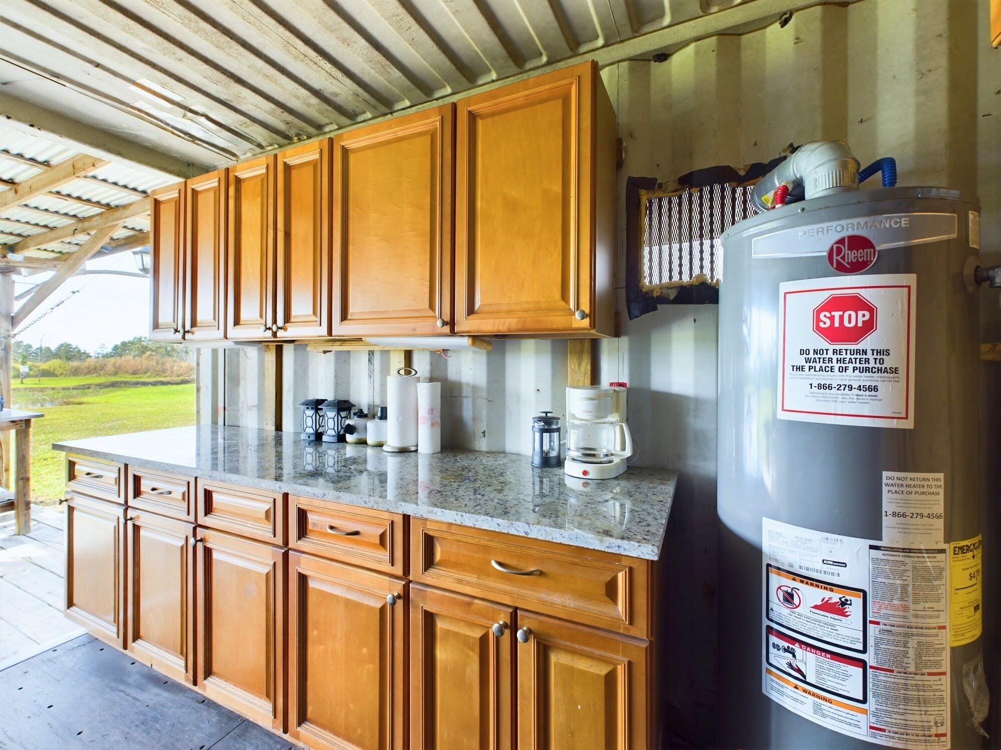 1224001 Holopaw Groves Rd Street St. Cloud, FL 34773 - Photo 69 of 99 a kitchen with stainless steel appliances granite countertop a sink and a cabinets