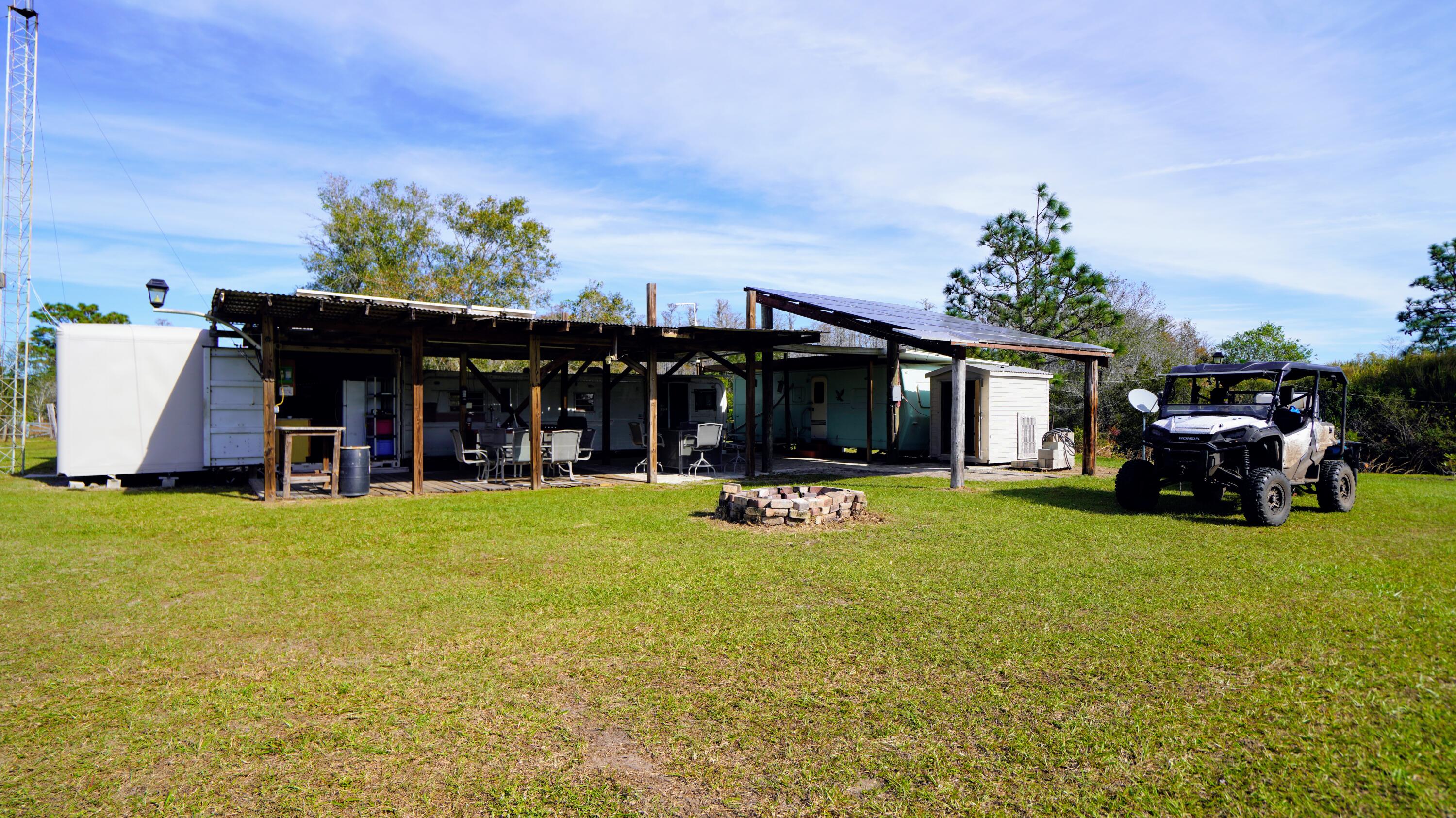 1224001 Holopaw Groves Rd Street St. Cloud, FL 34773 - Photo 7 of 99 a view of a house with patio and garden