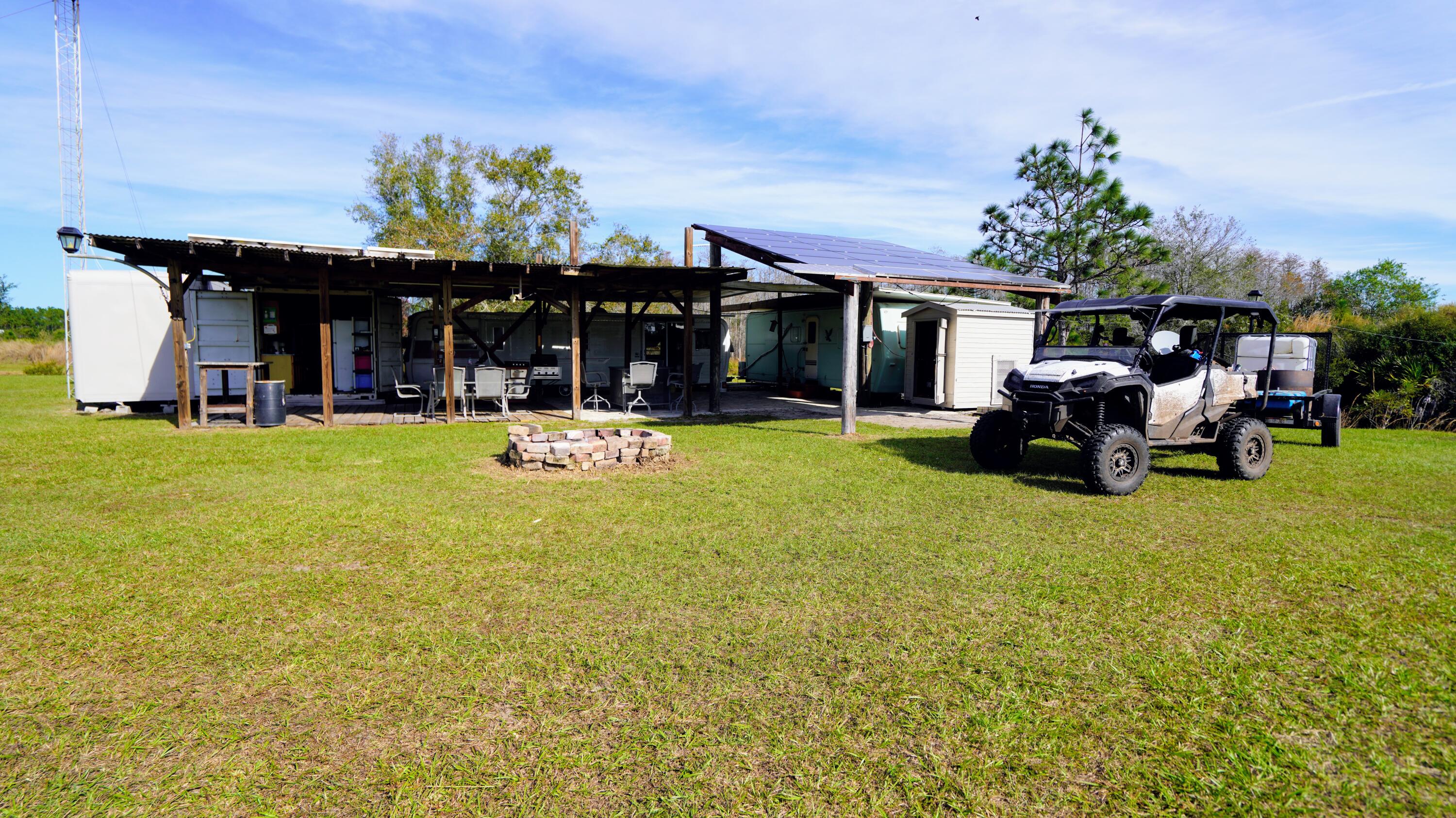 1224001 Holopaw Groves Rd Street St. Cloud, FL 34773 - Photo 8 of 99 a view of a house with swimming pool and sitting area