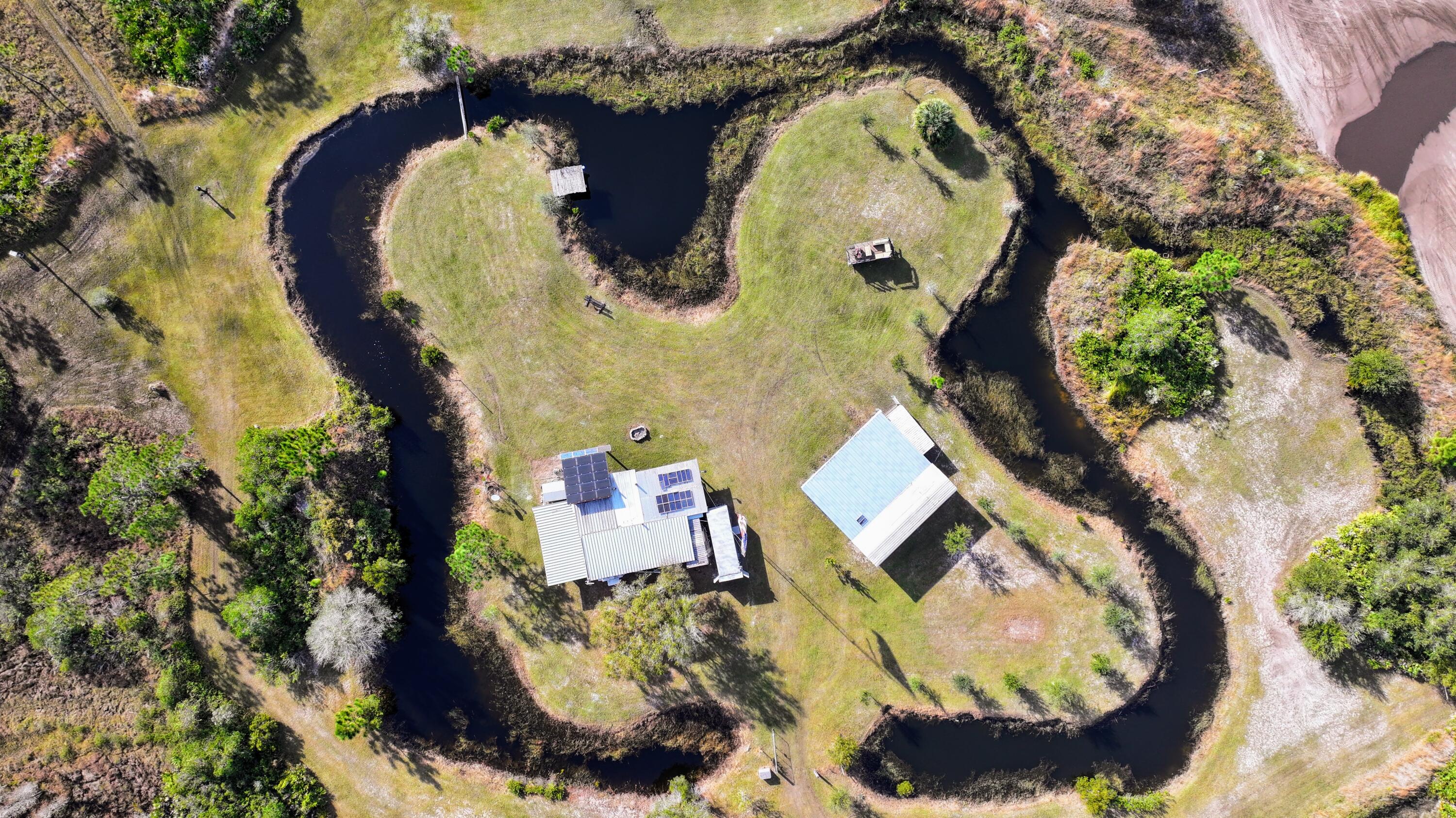 1224001 Holopaw Groves Rd Street St. Cloud, FL 34773 - Photo 84 of 99 an aerial view of a house with swimming pool and outdoor space