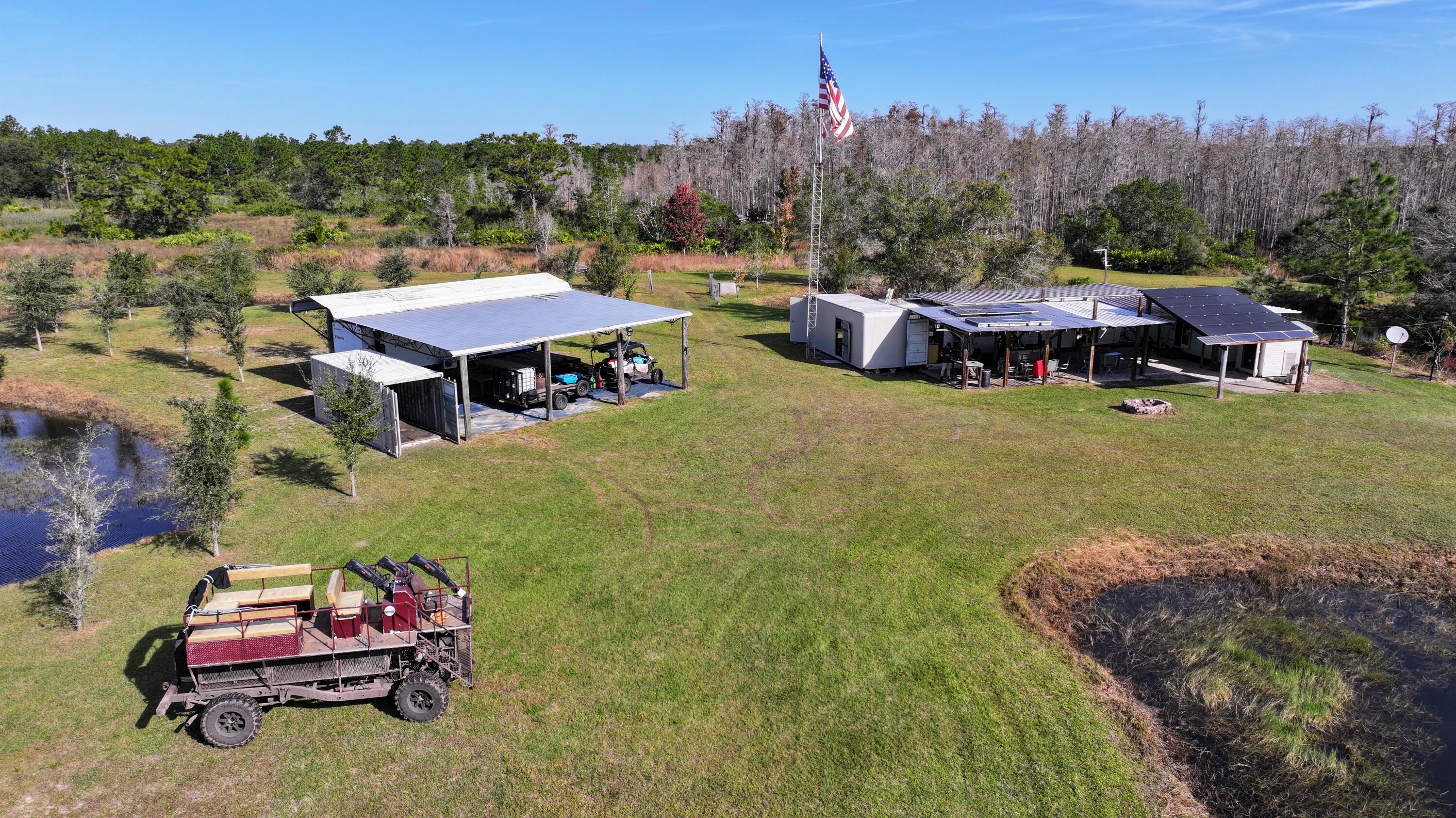 1224001 Holopaw Groves Rd Street St. Cloud, FL 34773 - Photo 92 of 99 an aerial view of a house with a garden and trees