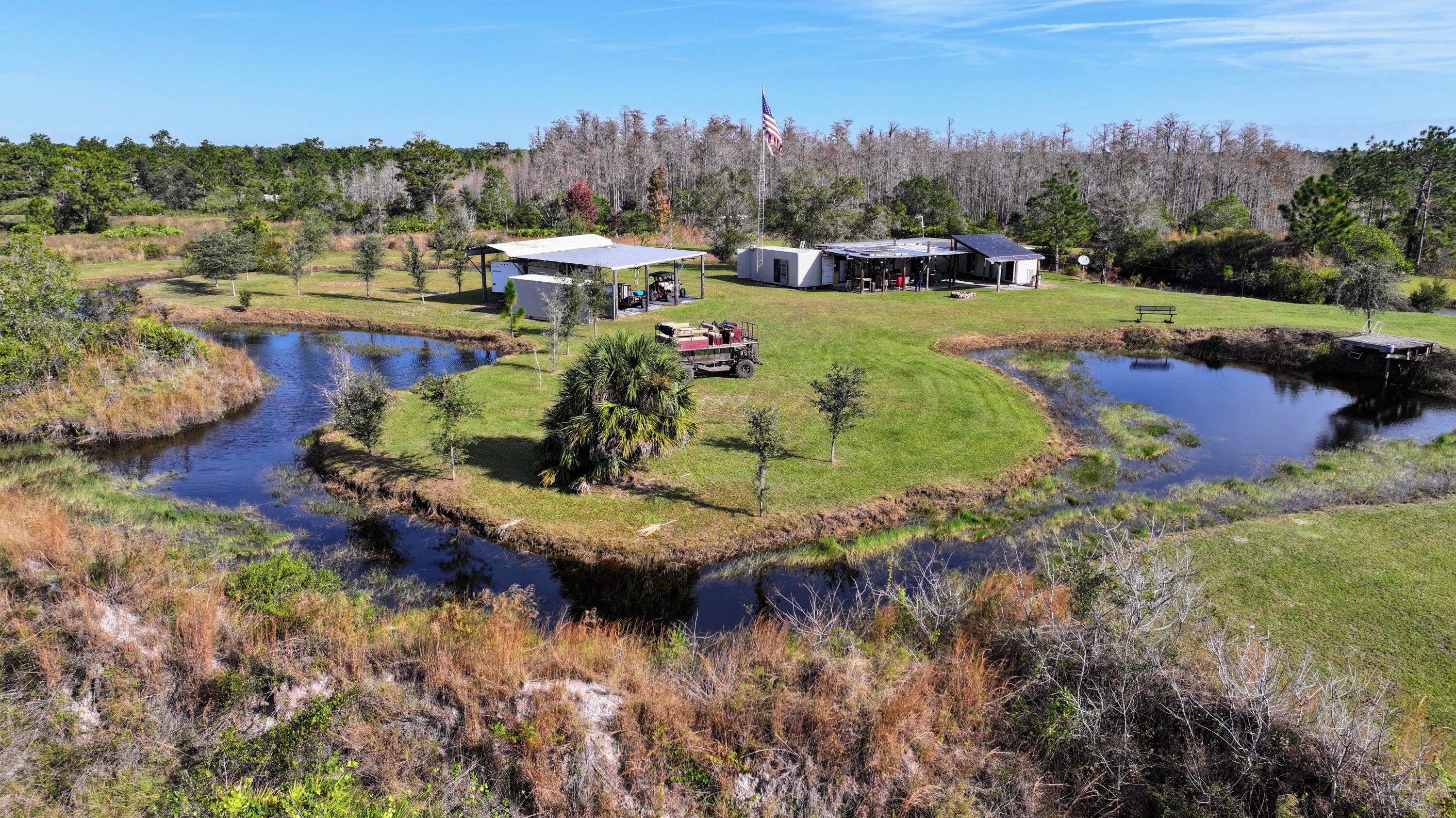 1224001 Holopaw Groves Rd Street St. Cloud, FL 34773 - Photo 93 of 99 a view of a lake in middle of the town