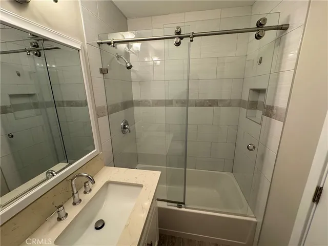 a bathroom with a tub a sink and shower