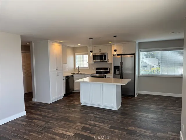 a kitchen with stainless steel appliances a refrigerator stove microwave and cabinets