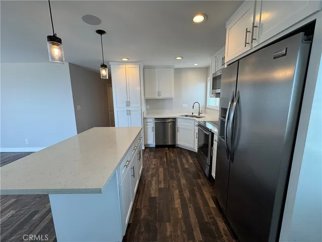 a kitchen with stainless steel appliances a refrigerator and a stove